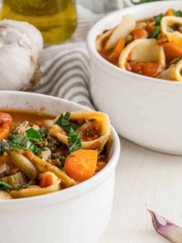 Image shows a two bowls of Best Vegan Minestrone Soup Recipe.