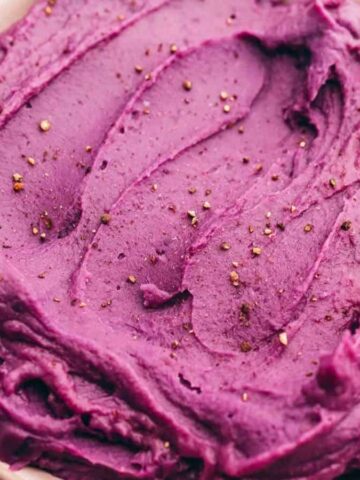 Smooth and creamy mashed purple sweet potatoes served in a bowl.