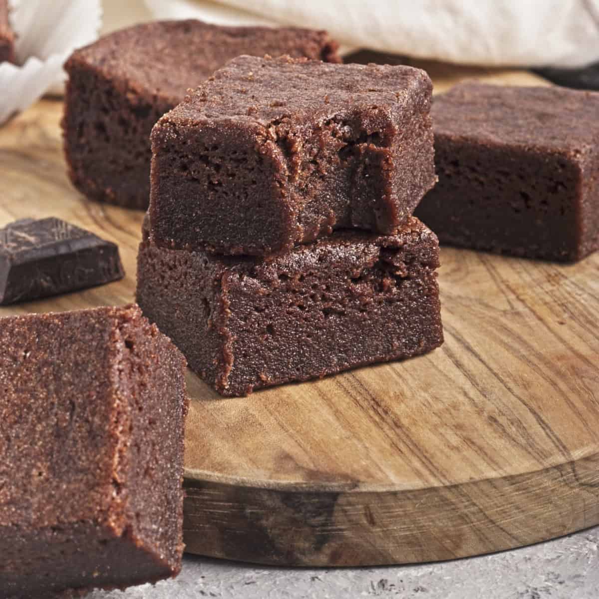 Vegan Chocolate Butter Mochi on a brown cutting board.