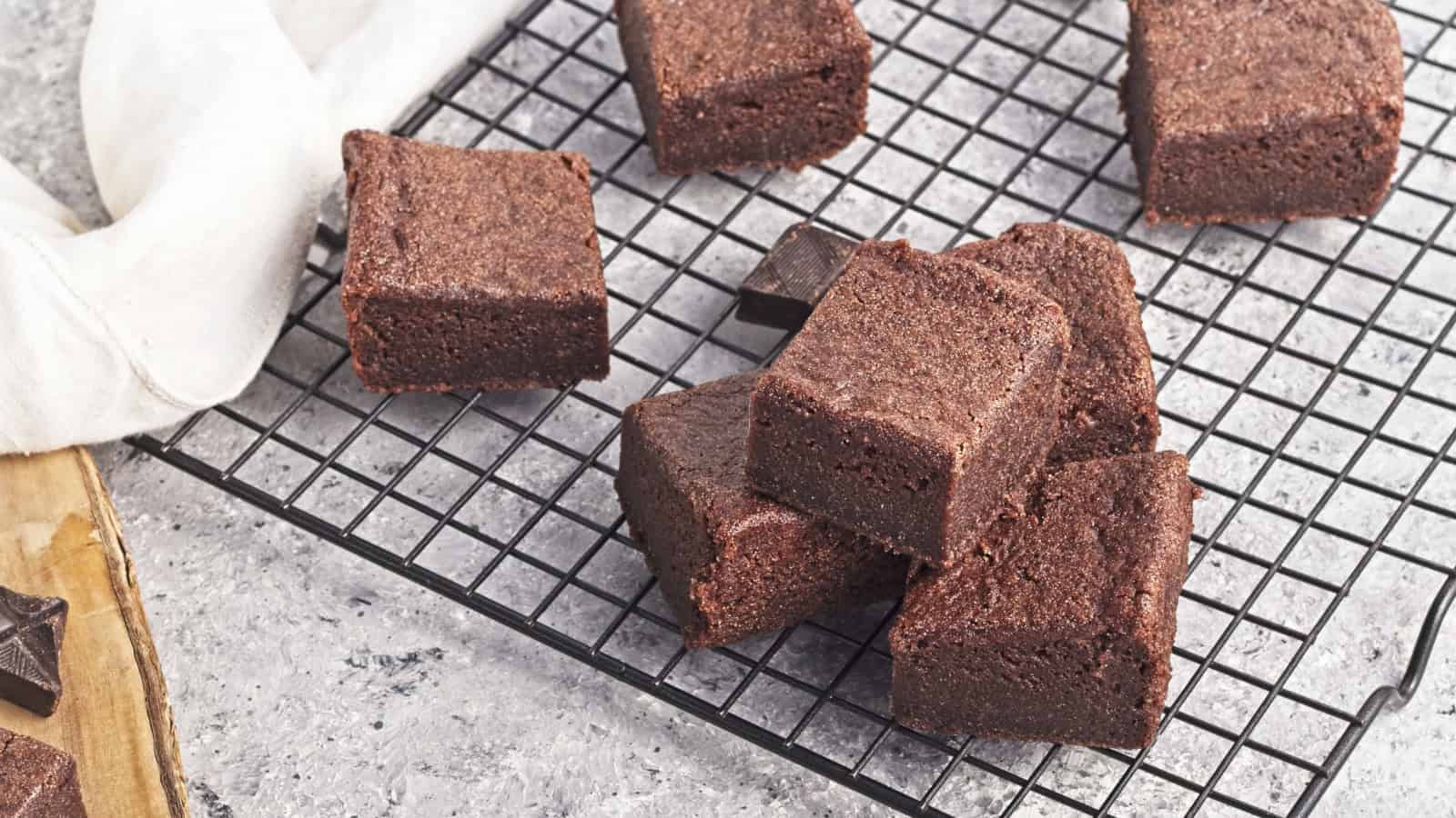 Chocolate butter mochi squares with a chewy and glossy texture.