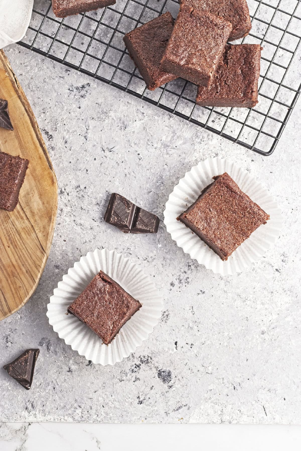 Vegan Chocolate Butter Mochi on a rack and cupcake liners.