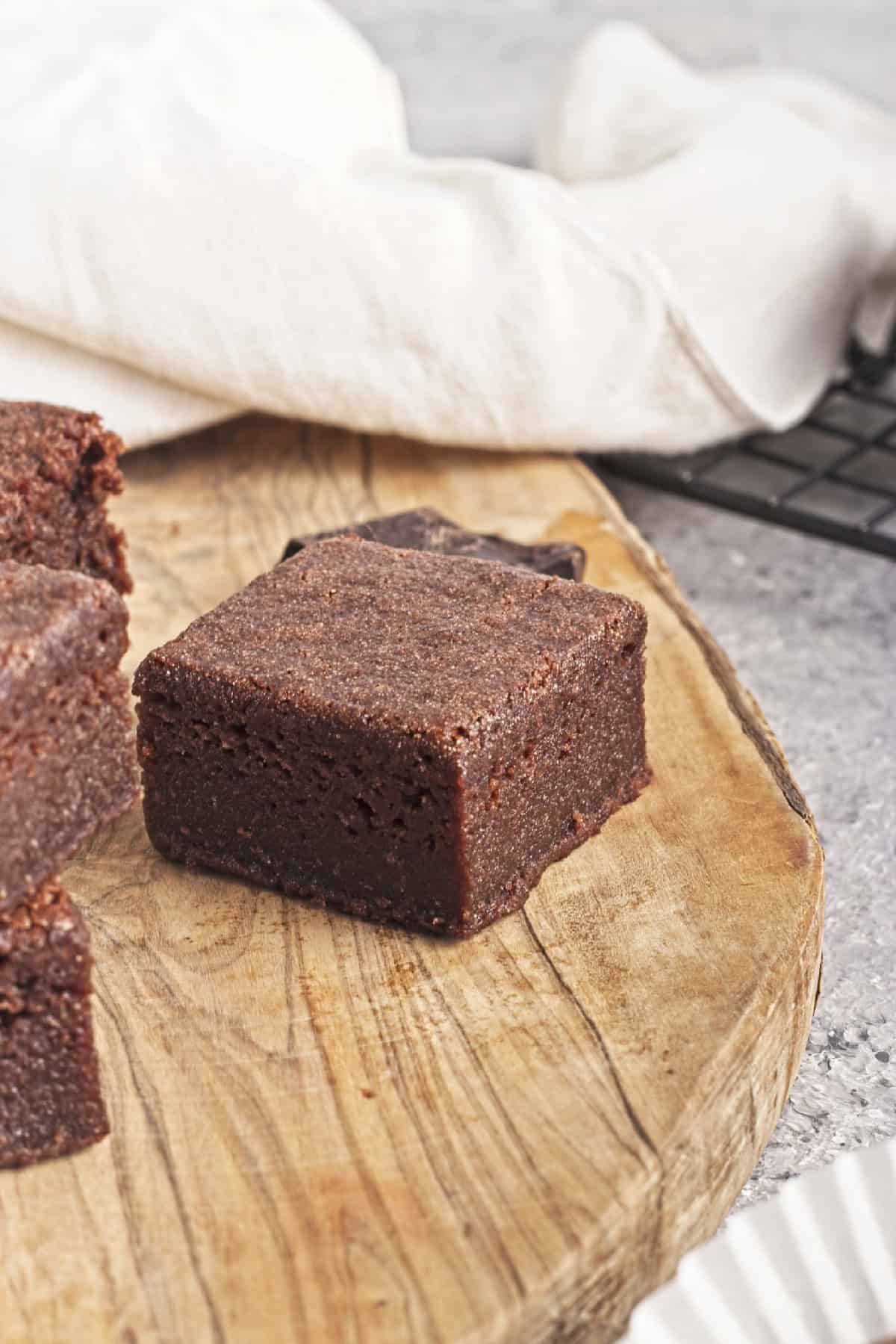 A delicious chocolate mochi rests on a cutting board.