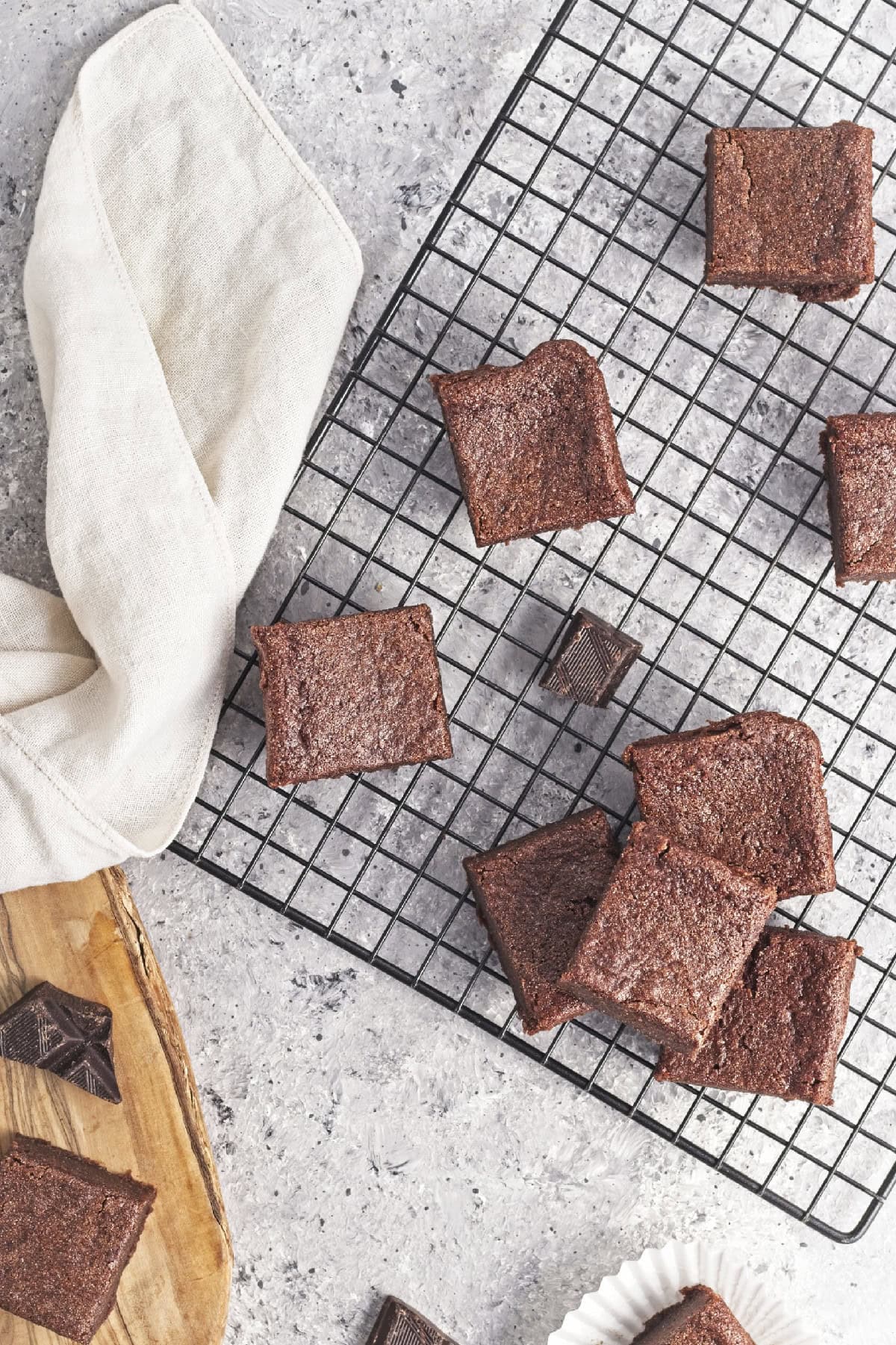 Delicious chocolate mochi rests on a black cooking rack.