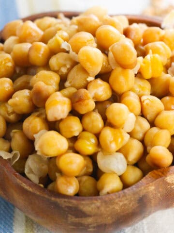 Close-up of cooked Instant Pot chickpeas in a wooden bowl.