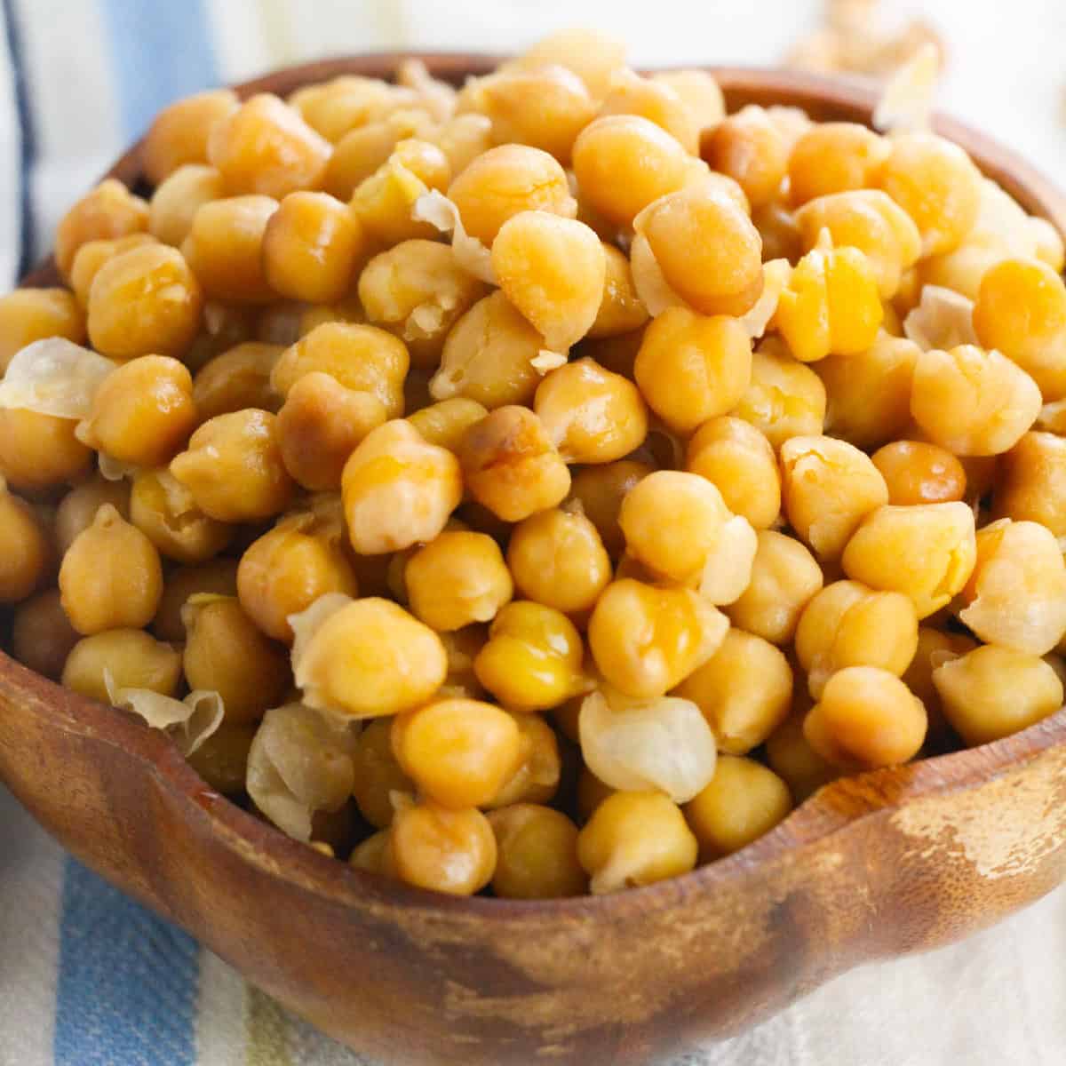 Close-up of cooked Instant Pot chickpeas in a wooden bowl.