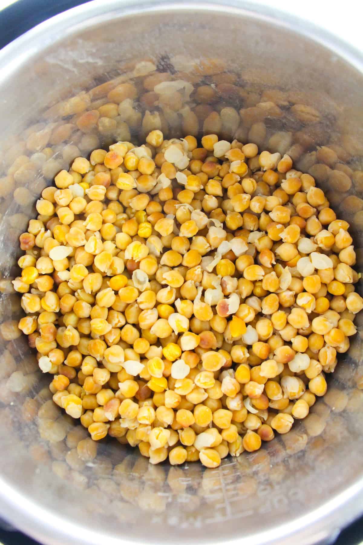 Fully cooked chickpeas in the Instant Pot after pressure cooking, ready to use in recipes.
