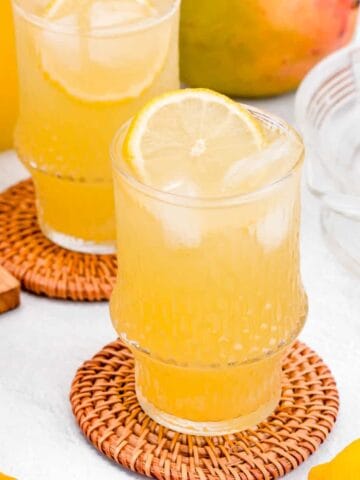 Mango lemonade are displaying on a table.