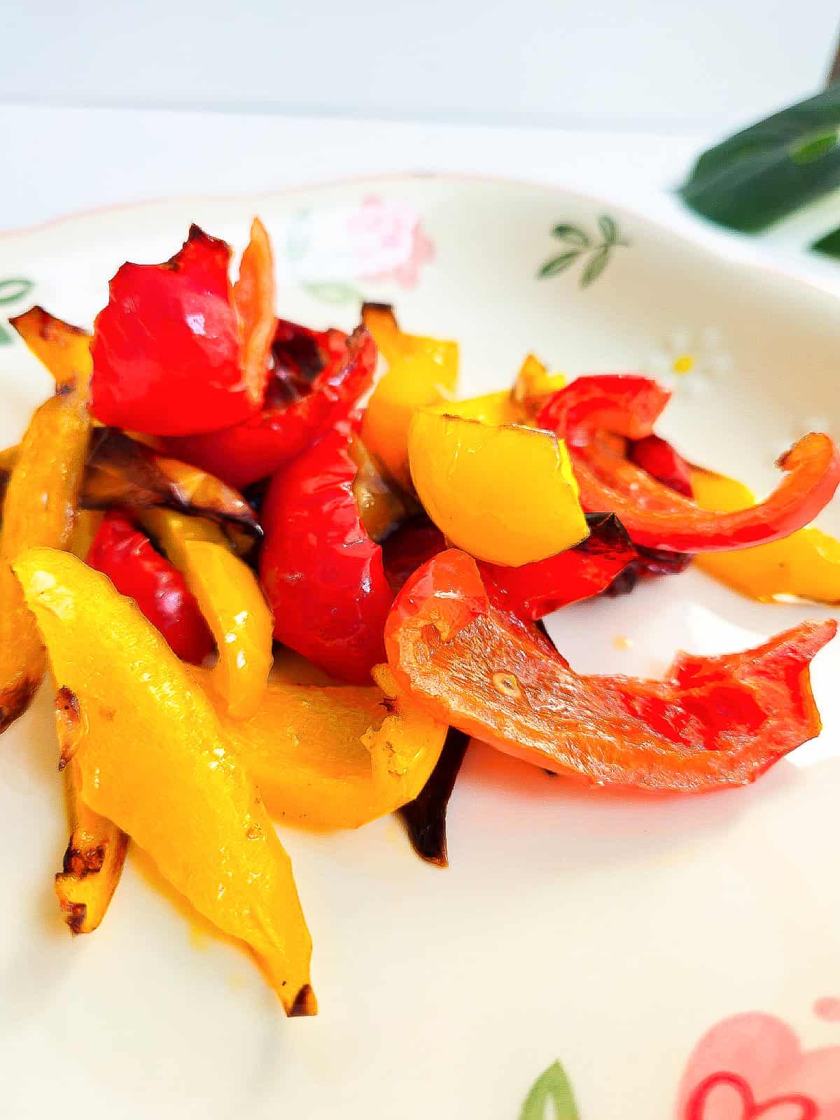 Juicy, roasted red and yellow peppers with golden edges, ready to serve as a side dish.
