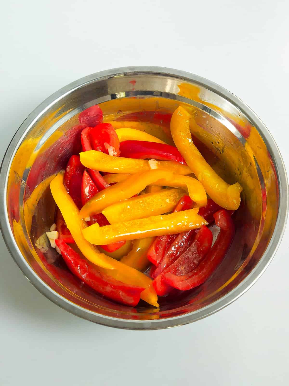 Red and yellow bell peppers tossed in olive oil and garlic before air frying.