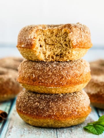Baked apple cider donuts dusted with sugar.