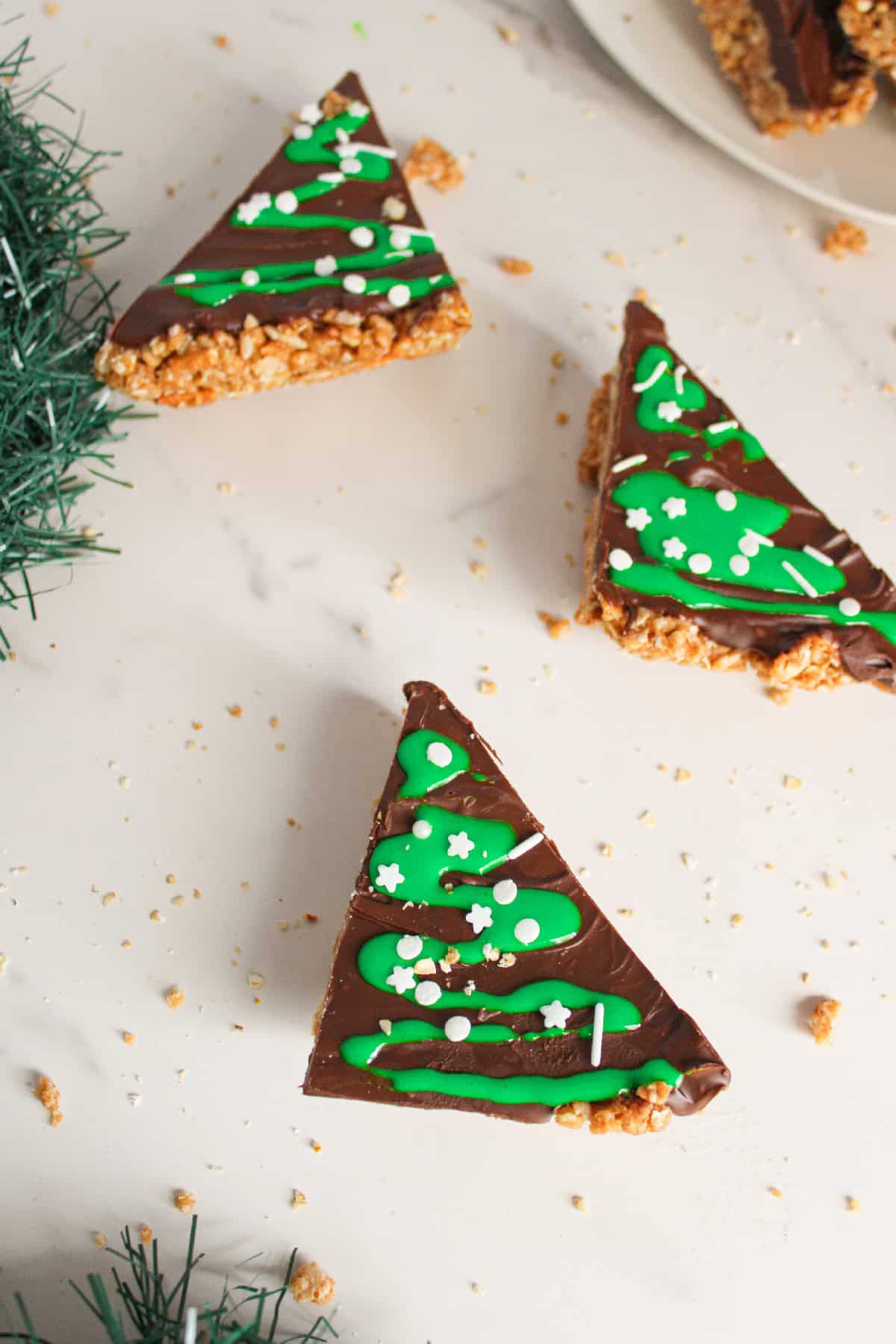 Festive peanut butter Christmas tree bars displayed flat on a white surface for holiday dessert serving.