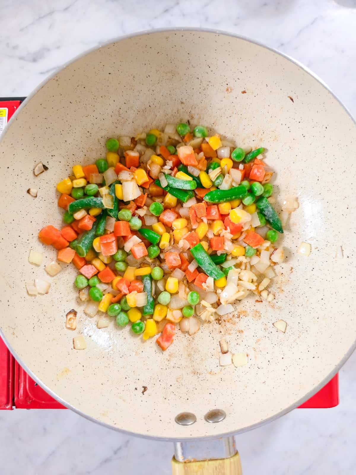 Saut&eacute;ed onions with freshly minced garlic cooking in a pan.