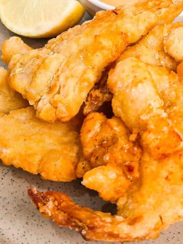 Detailed close-up of crispy oyster mushrooms cooked in the air fryer on a gray plate.