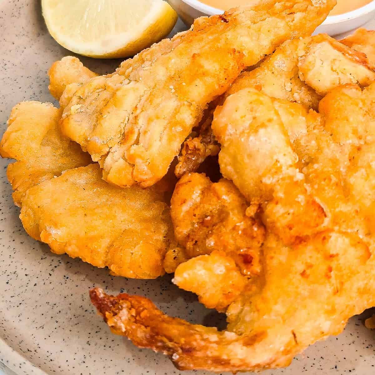 Detailed close-up of crispy oyster mushrooms cooked in the air fryer on a gray plate.
