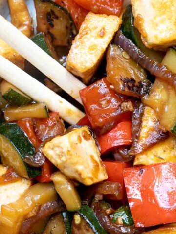 Stir-fried zucchini and tofu in a pan.