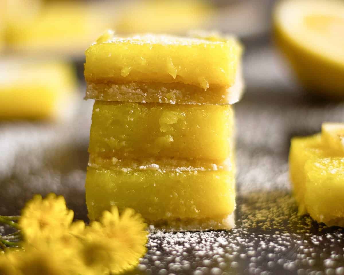 A stack of lemon bars with powdered sugar on top, chili's spicy shrimp tacos.	