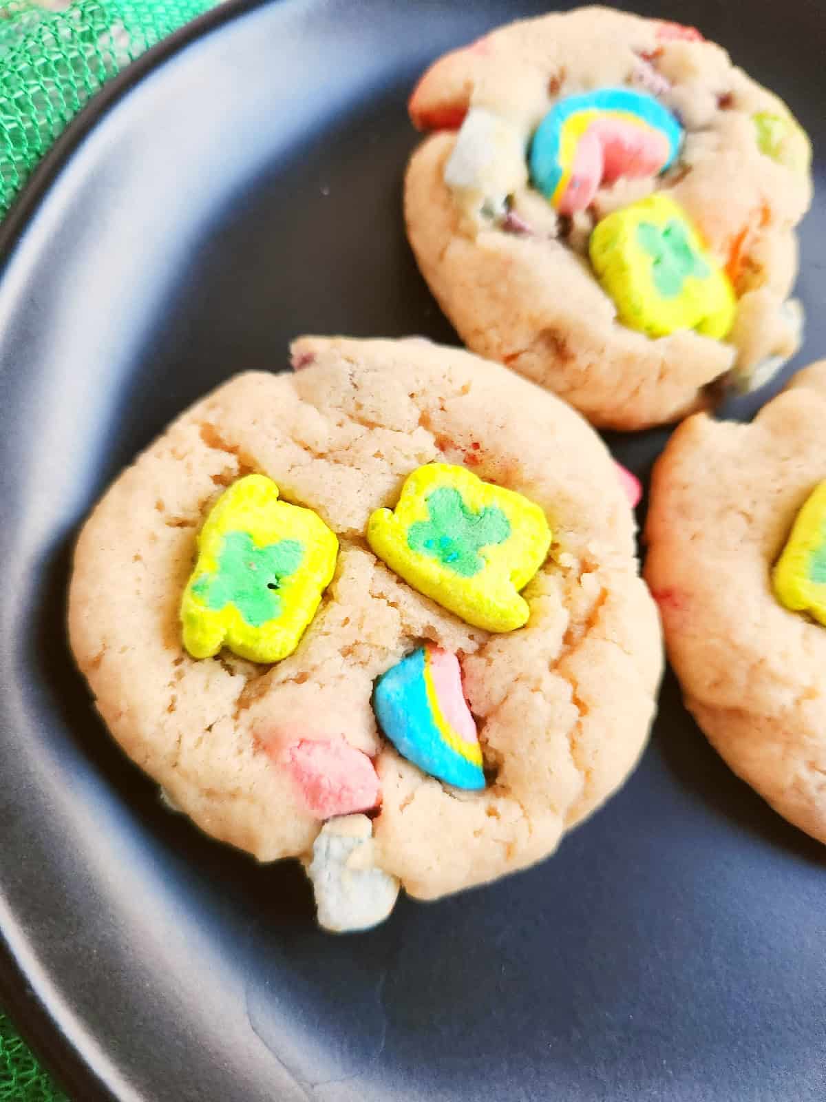 Close-up of a Lucky Charms cookie with colorful marshmallow cereal pieces.