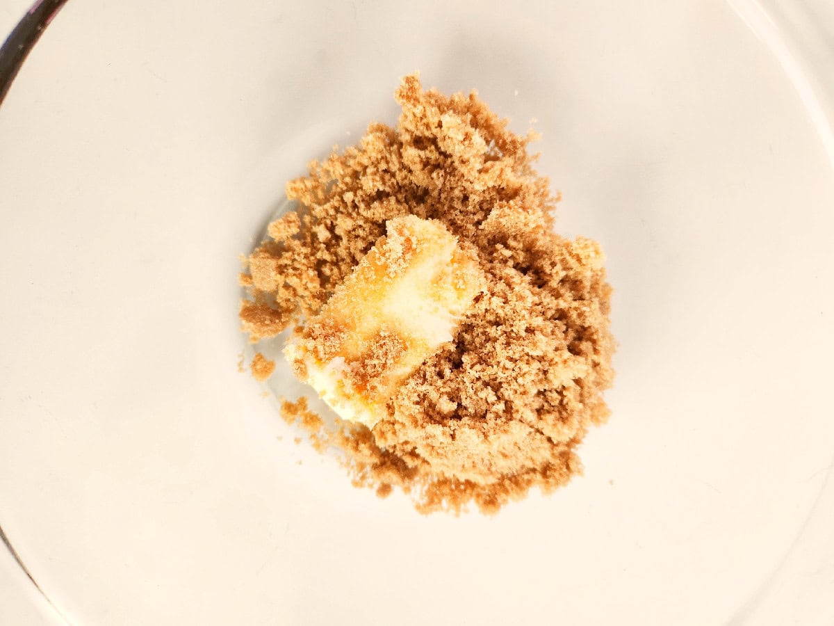 Butter and brown sugar being mixed together in a bowl to start cookie dough.