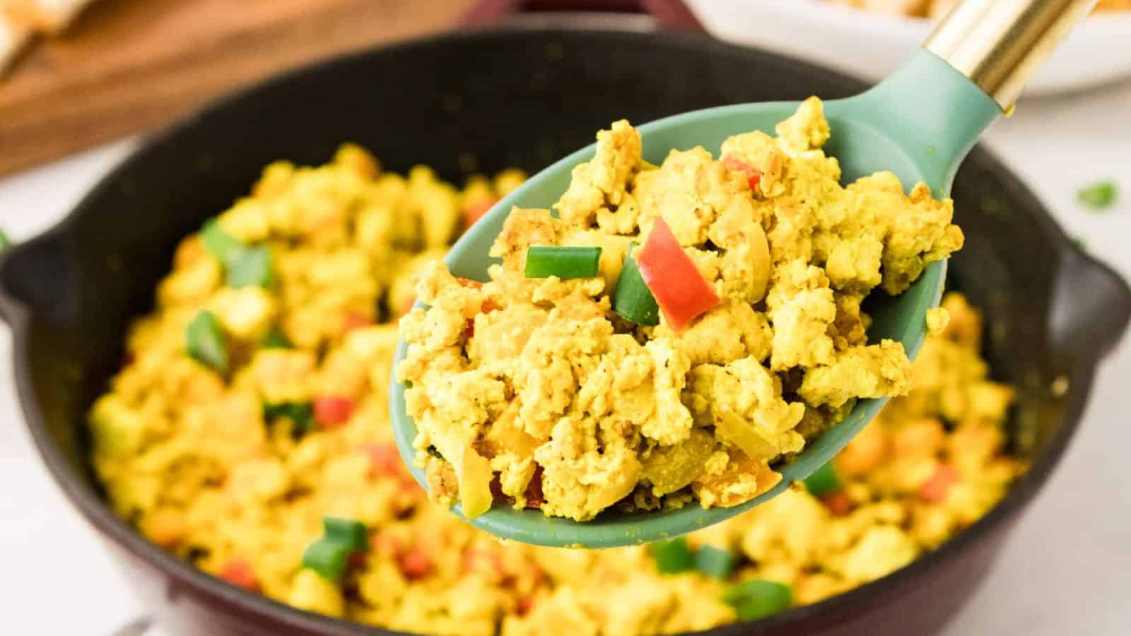 Tofu scramble cooked with vegetables and spices until fluffy and lightly golden.
