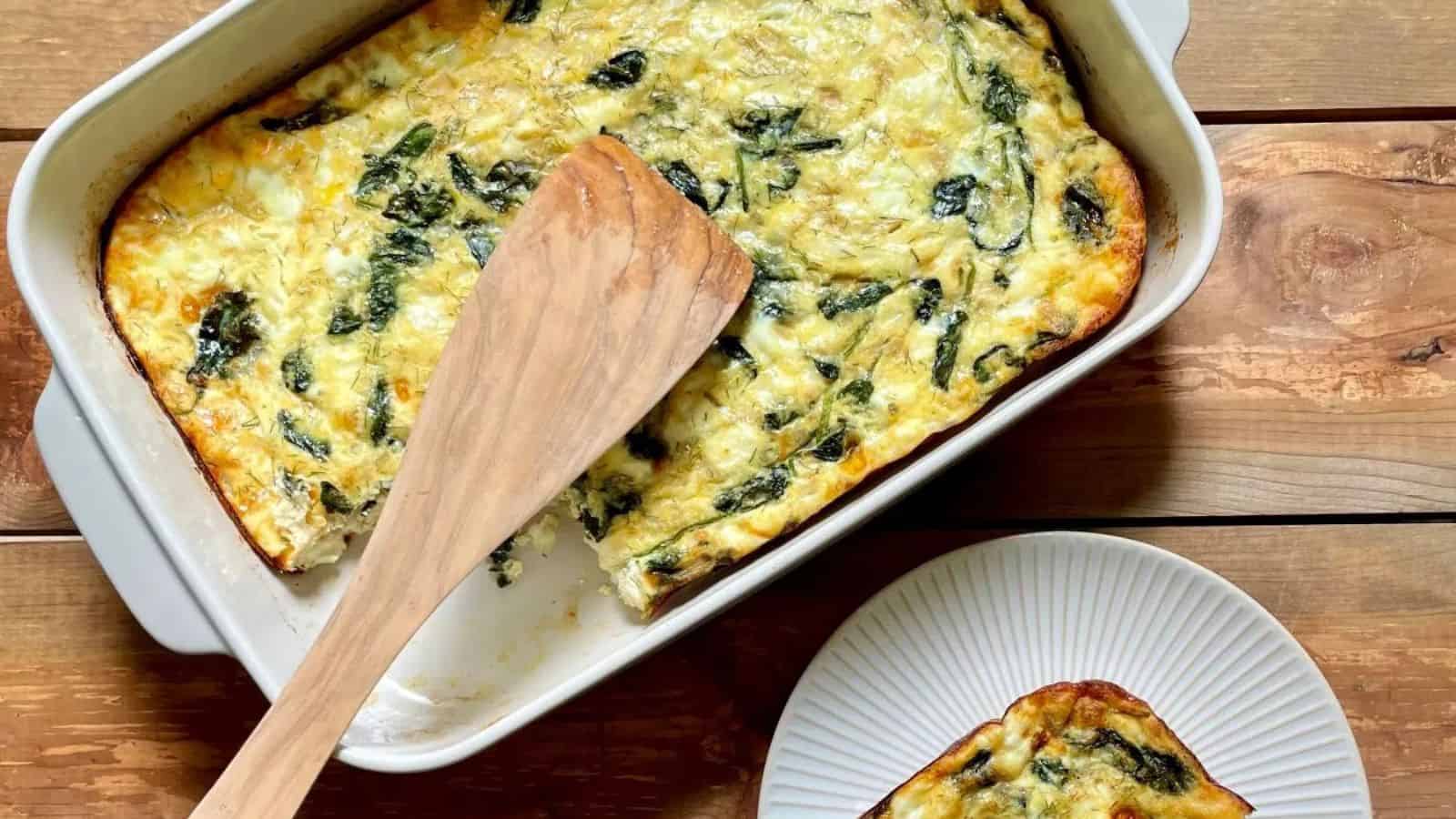 Feta spinach breakfast casserole layered with eggs, greens, and melted cheese.