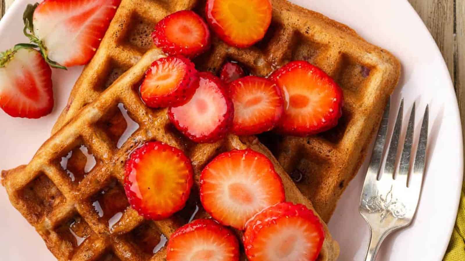 Strawberry waffles topped with fresh berries and cooked until crisp and fluffy.