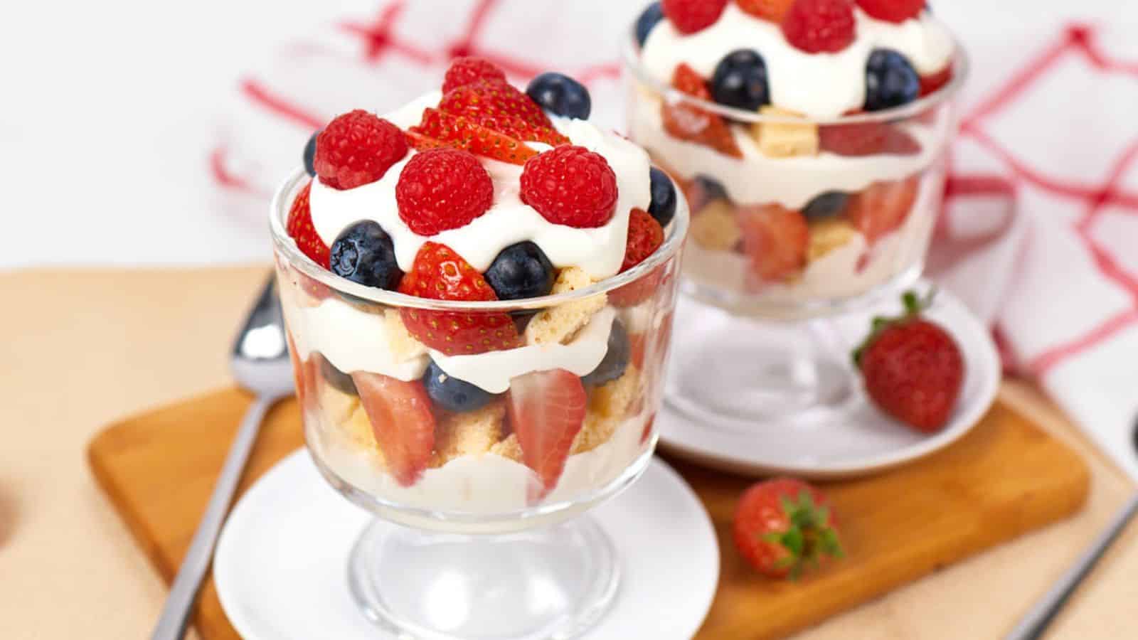 Greek yogurt berry trifle layered with fresh berries, creamy yogurt, and soft cake cubes.