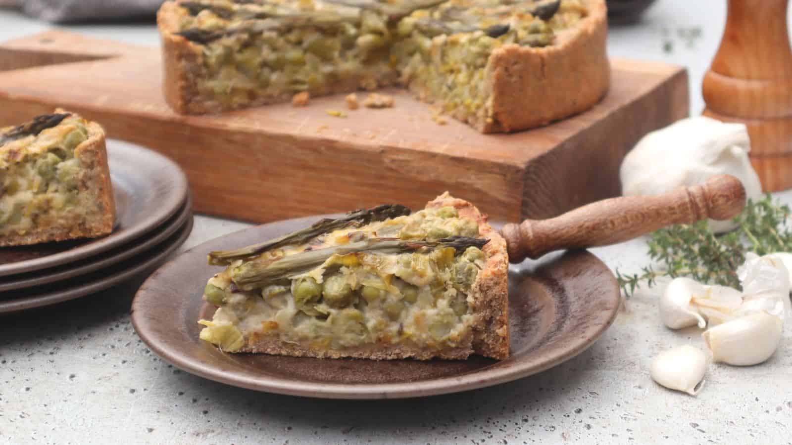 Vegan quiche filled with peas, asparagus, and leeks baked in a savory crust.