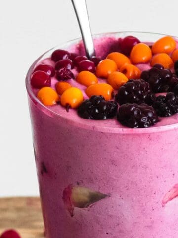 Berry banana milkshake blended smooth with a creamy texture and vibrant color.