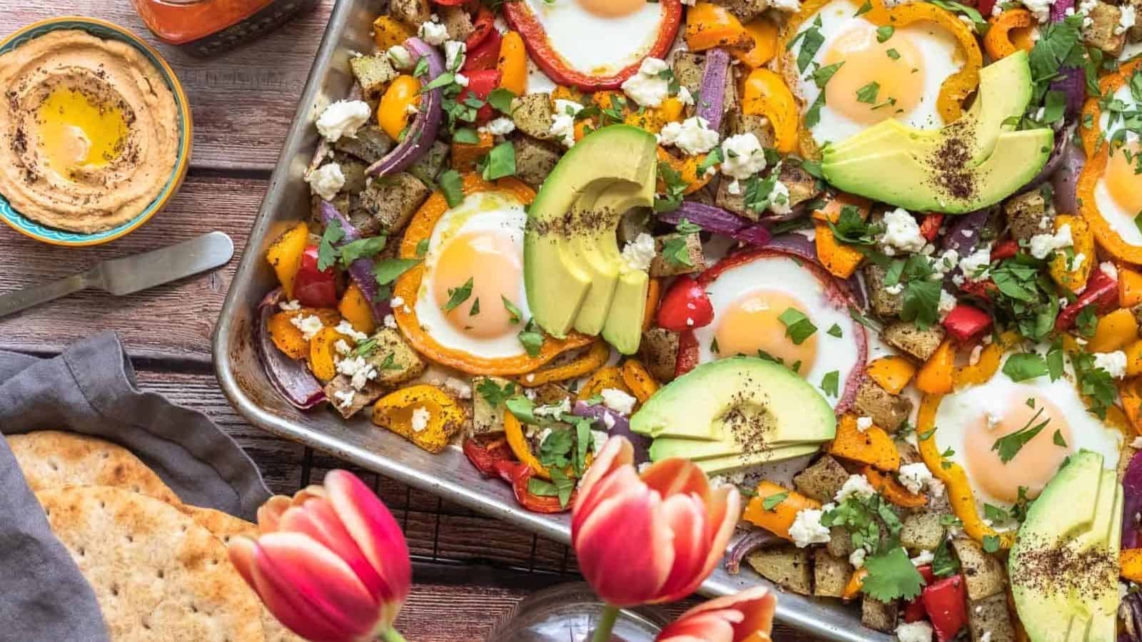 Sheet pan vegetables and eggs roasted with zaatar seasoning and golden edges.