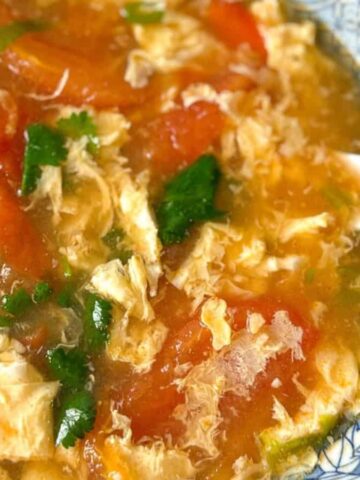 Tomato egg drop soup in a bowl.