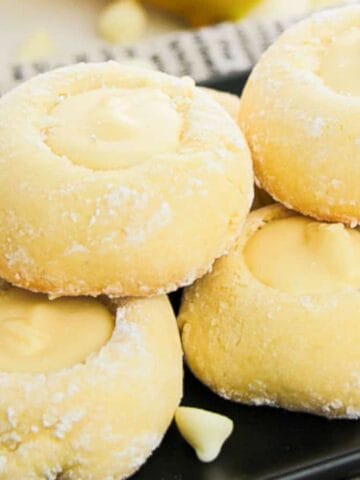 Lemon White Chocolate Cookies on a black plate.