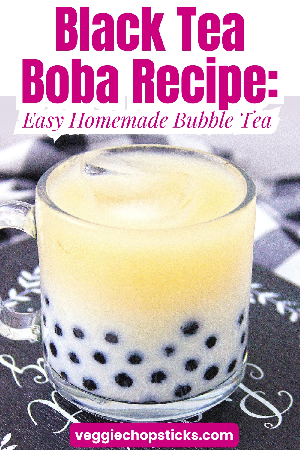 Black tea boba milk tea in a glass mug with tapioca black pearls.