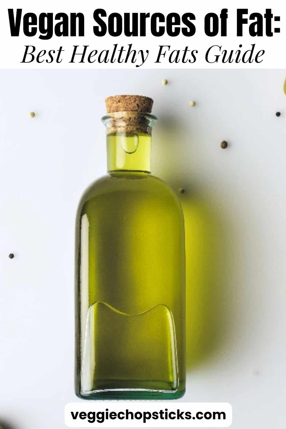 Olive oil in a glass bottle with olives, a heart-healthy vegan fat source.