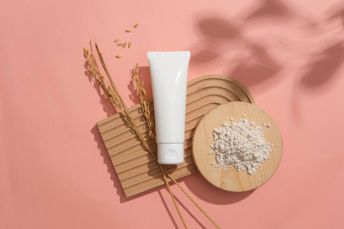 Minimalist vegan skincare product with natural ingredients on a soft pink background.