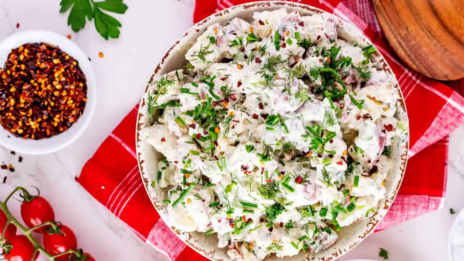 Potato salad mixed with sour cream and seasoning.