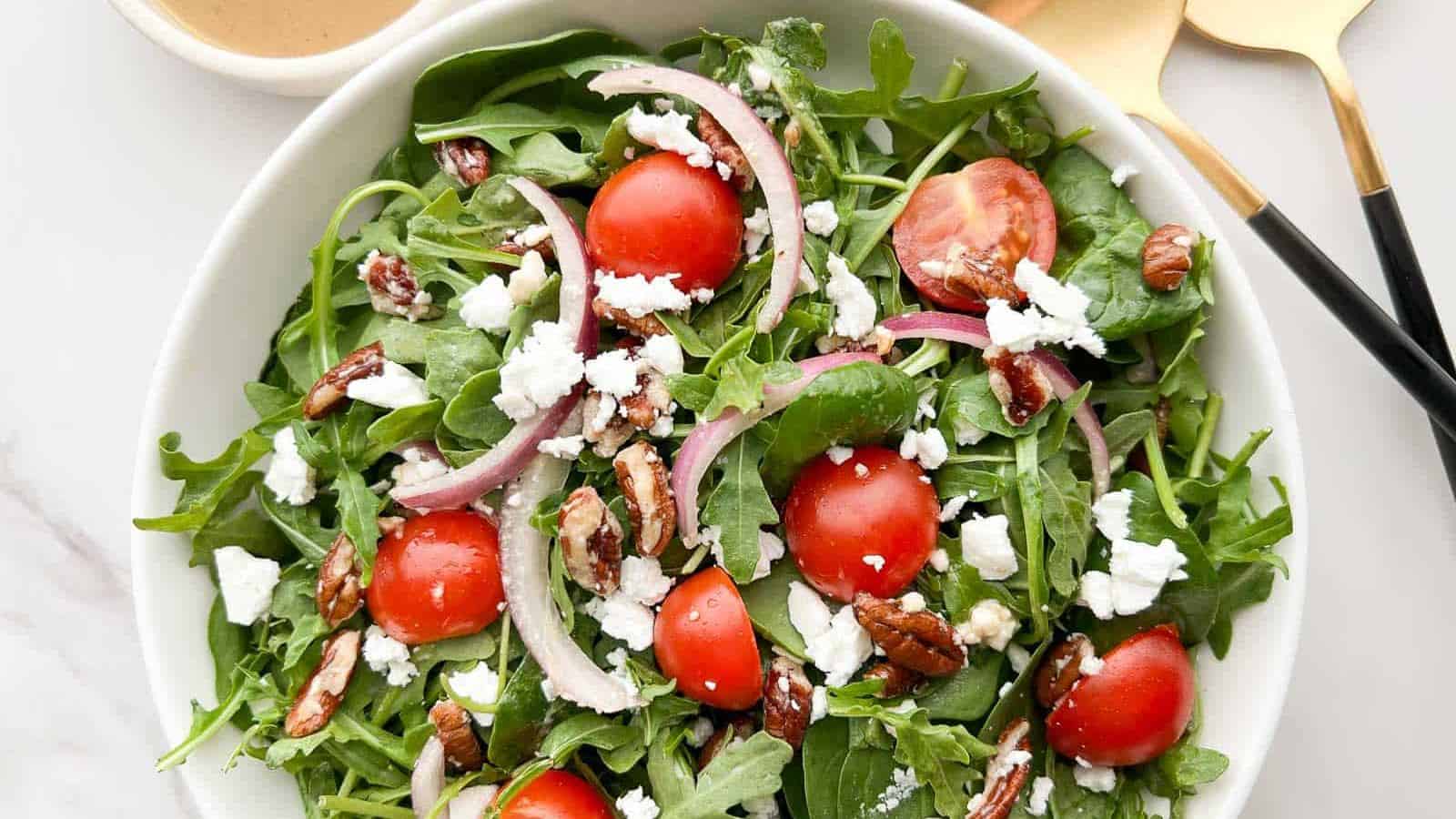 Arugula and spinach salad mixed with fresh greens and light dressing.