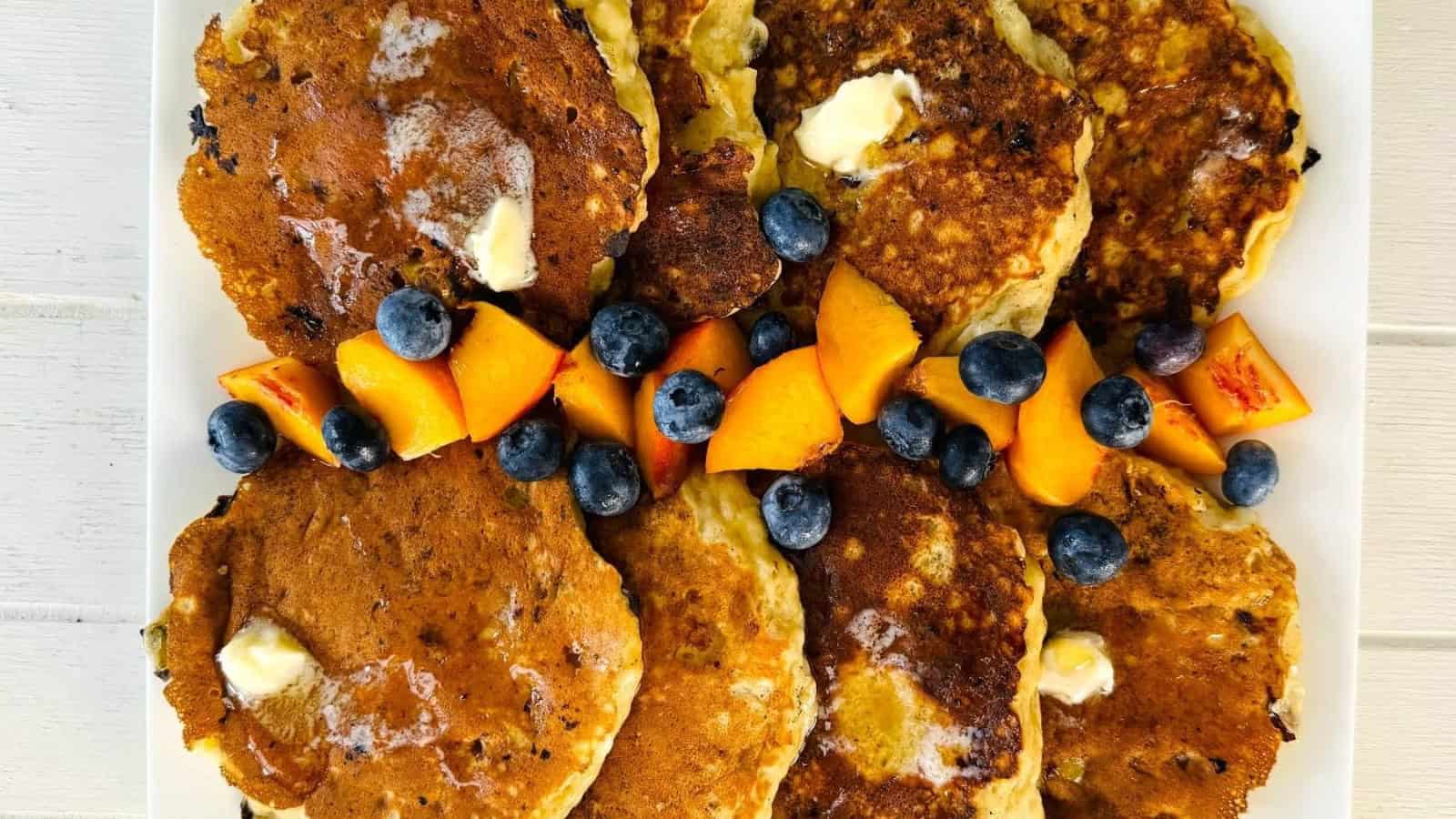 Protein pancakes stacked fluffy with sliced bananas on top.