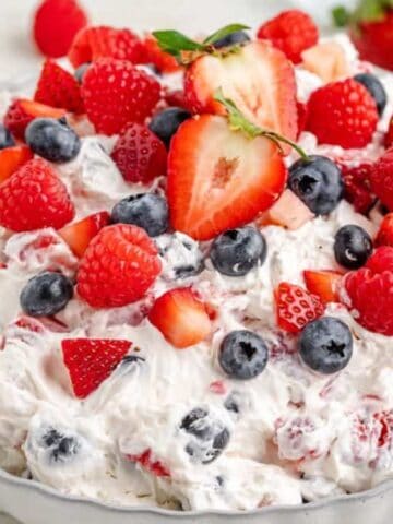 Cheesecake salad mixed with berries and creamy filling.