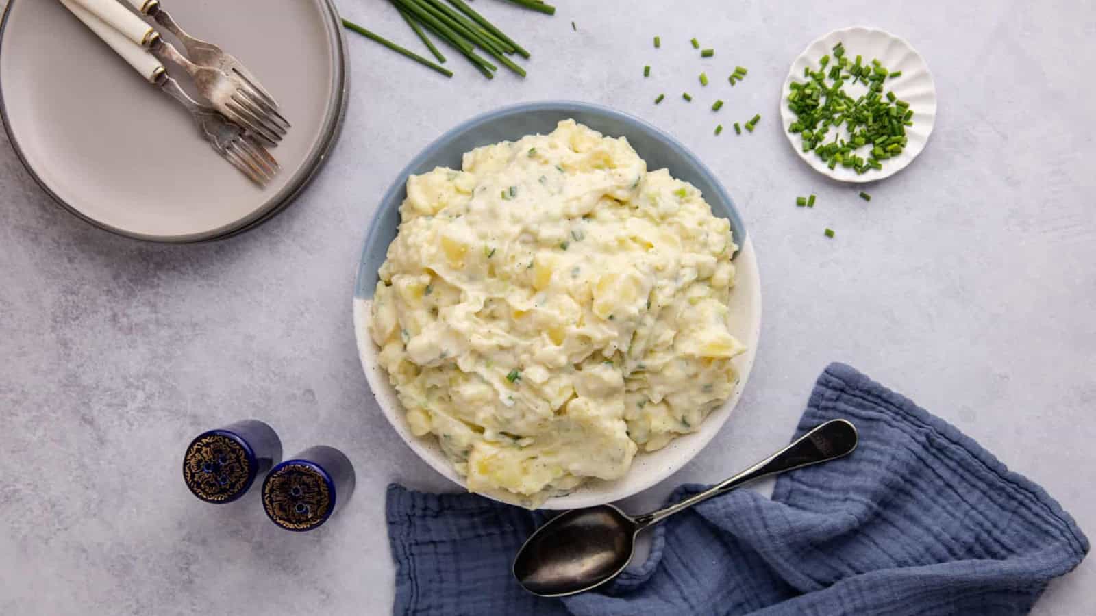 Egg-free potato salad tossed with creamy dressing and herbs.