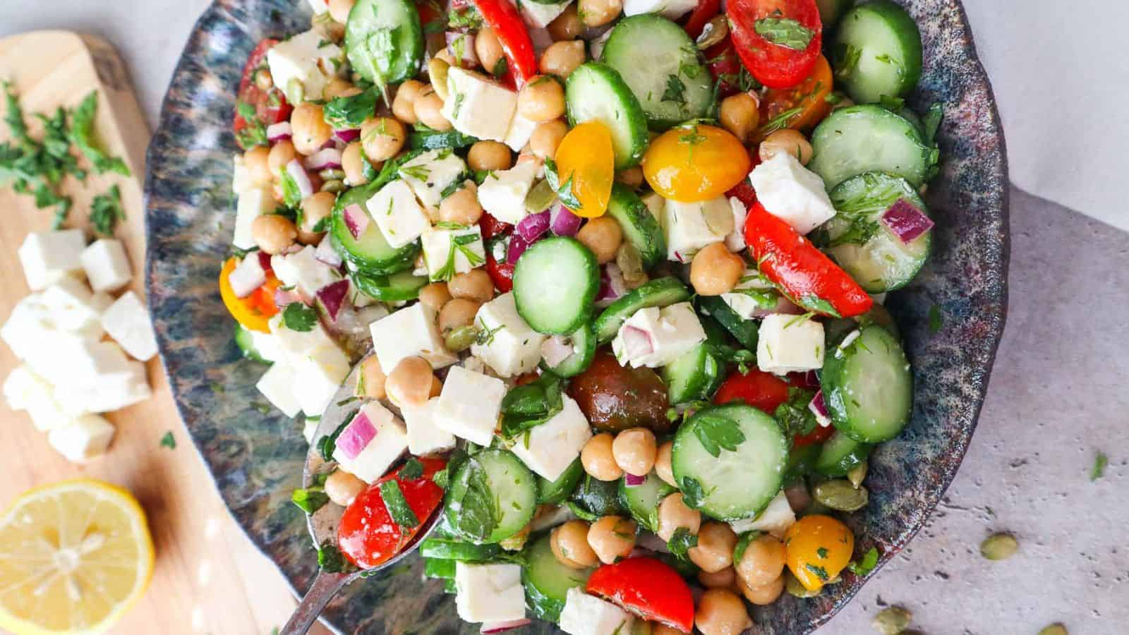 Cucumber chickpea feta salad tossed with fresh vegetables and tangy cheese.