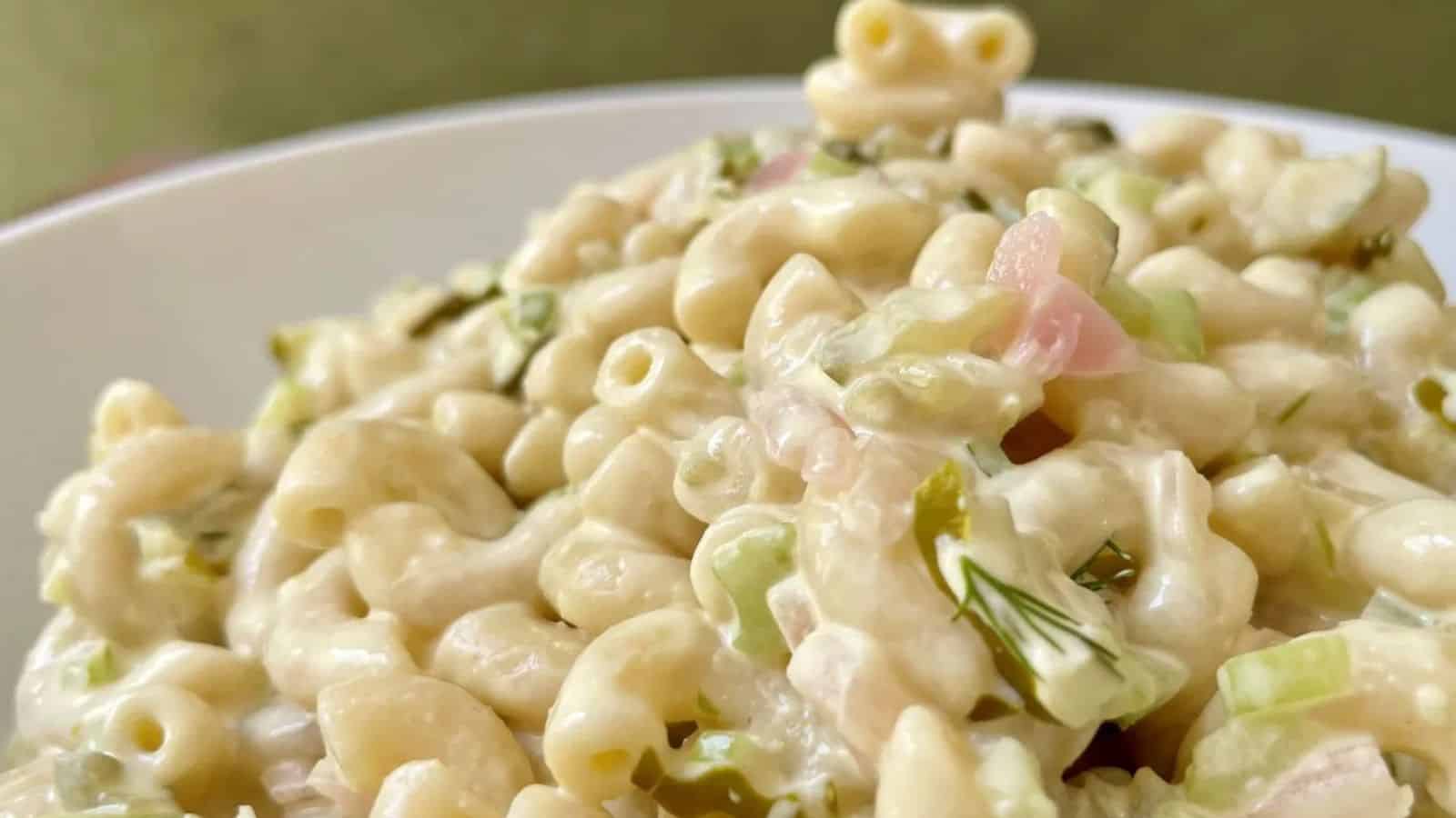 Macaroni salad mixed with dill pickles and creamy dressing.