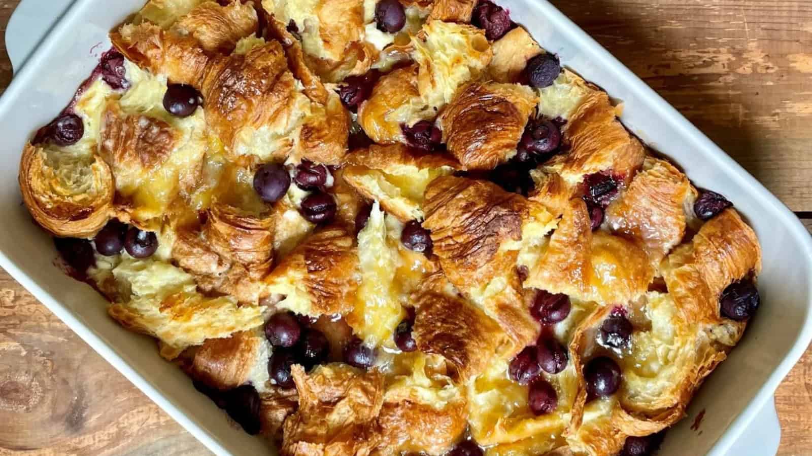 Breakfast casserole layered with croissants, eggs, and savory filling.
