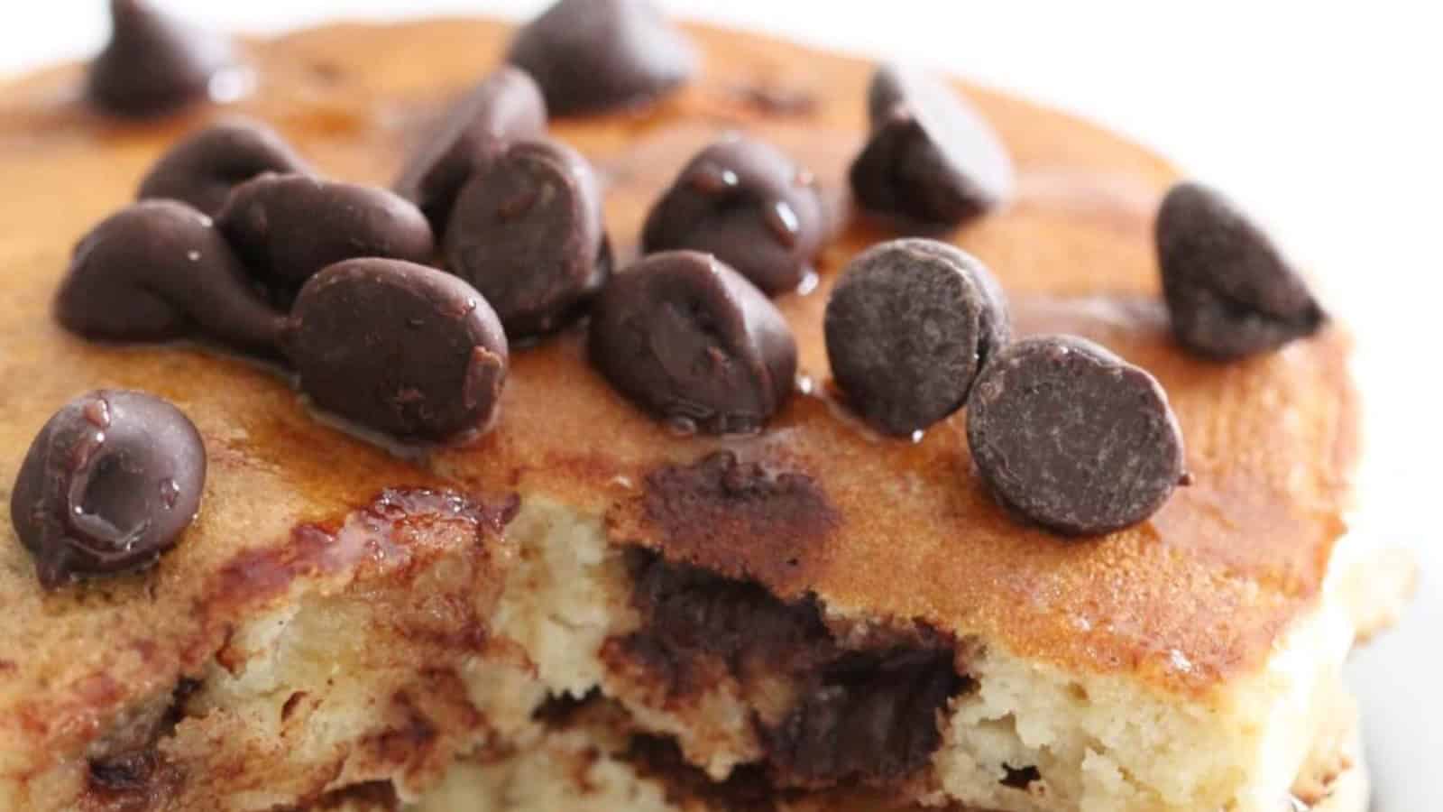 Chocolate chip pancakes stacked fluffy with melted chocolate pieces.