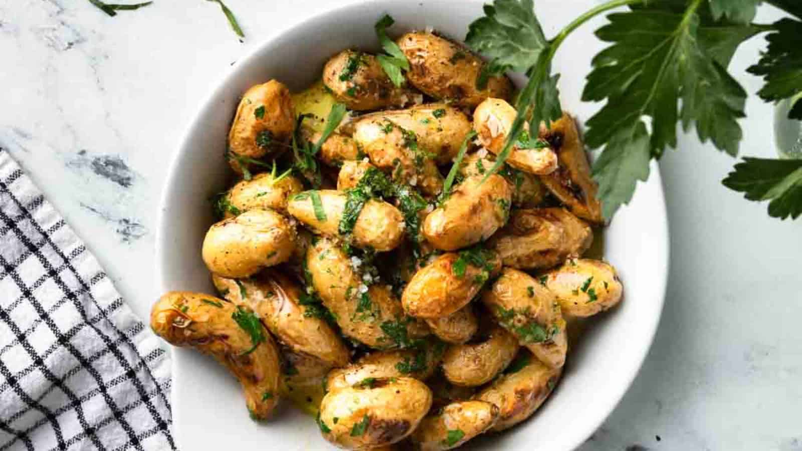 Fingerling potatoes grilled with seasoning and crispy golden edges.