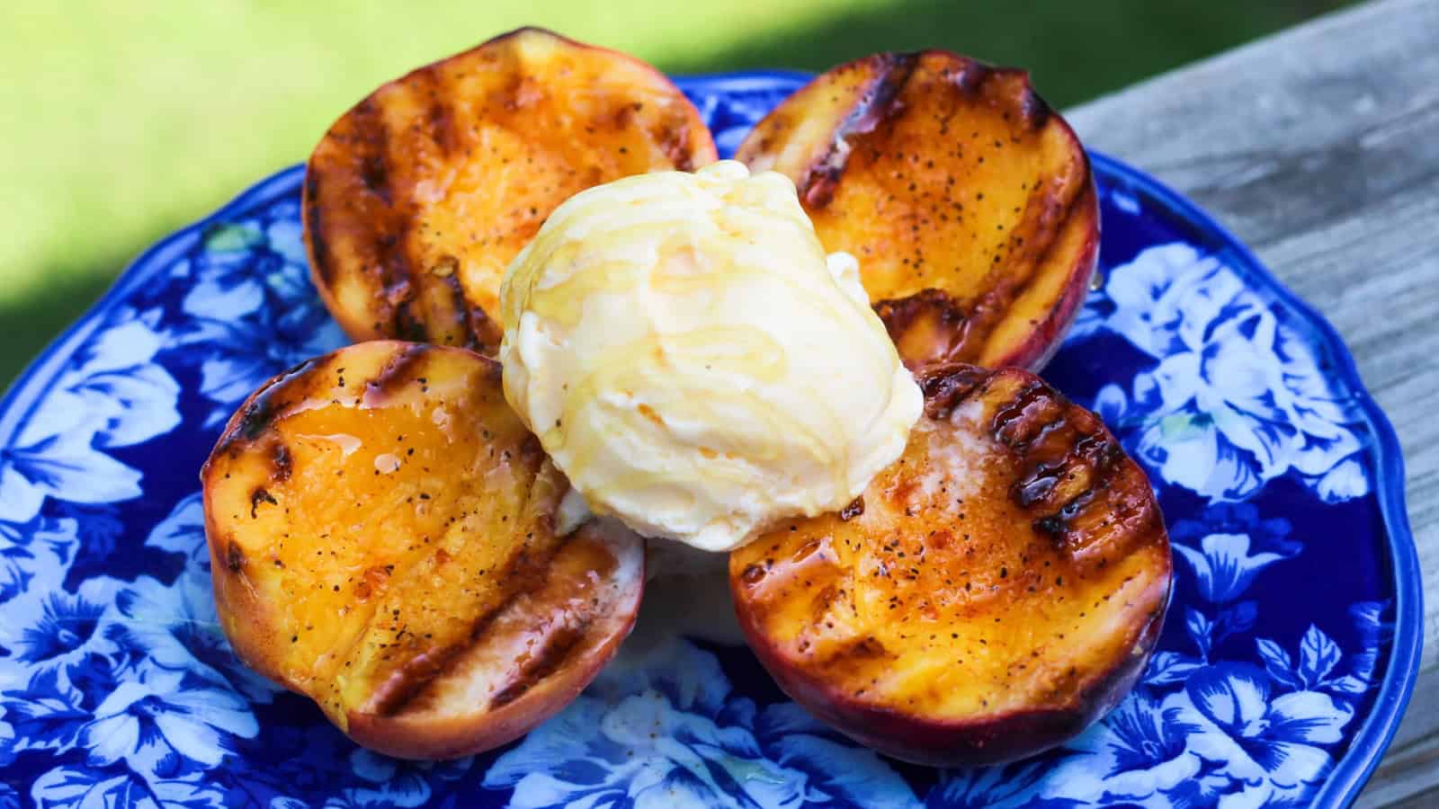Grilled peaches served with vanilla ice cream and caramelized edges.