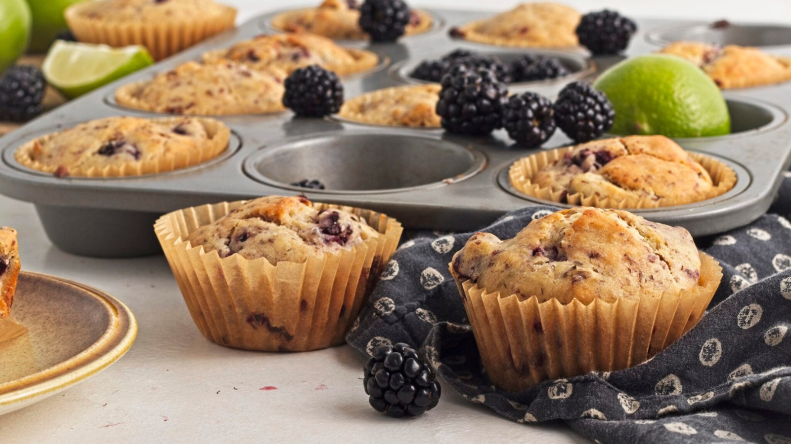 Blackberry muffins flavored with maple and lime with juicy berry pieces.