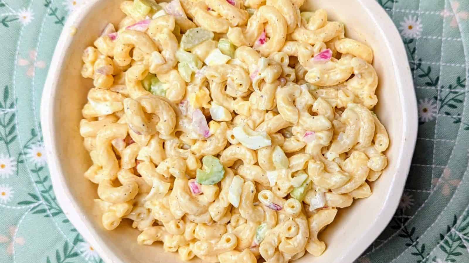 Macaroni salad mixed with pasta, vegetables, and creamy dressing.