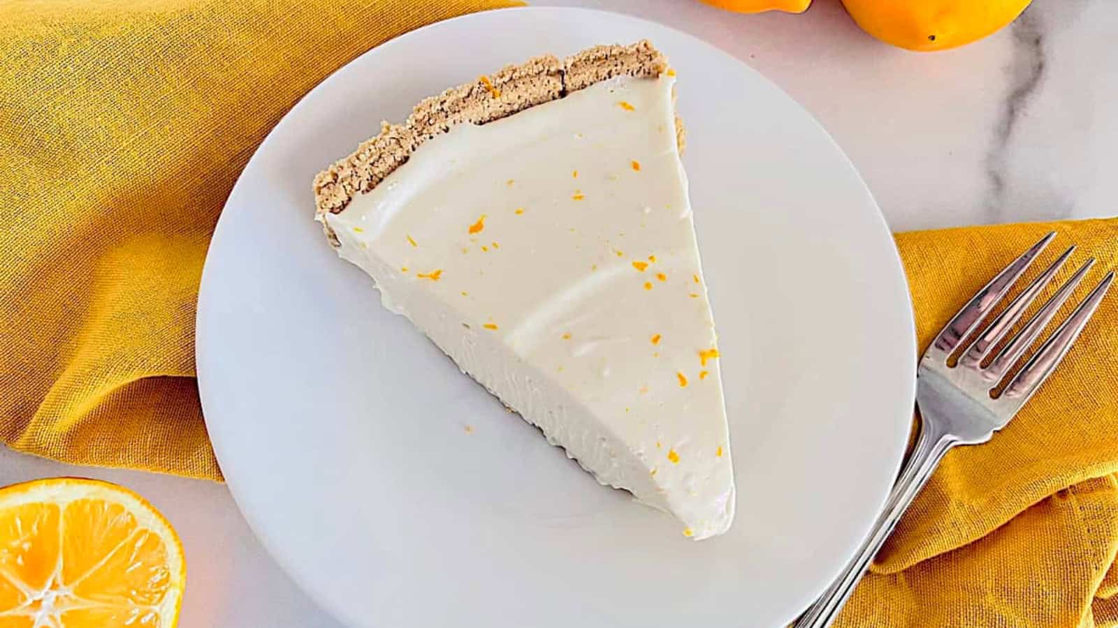 Lemon cheesecake pie with smooth citrus filling in a chilled crust.
