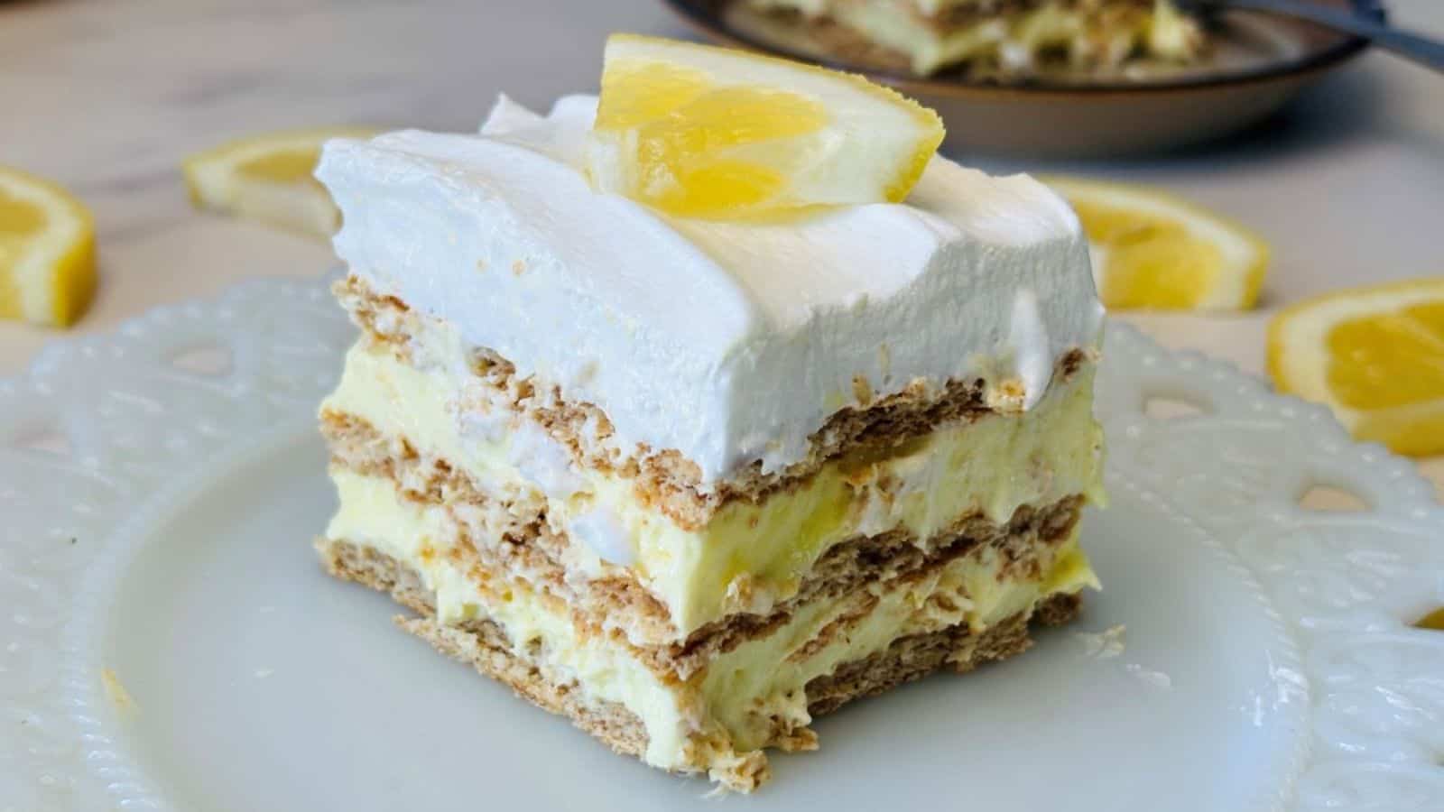 Lemon icebox cake layered with creamy filling and soft cookies.