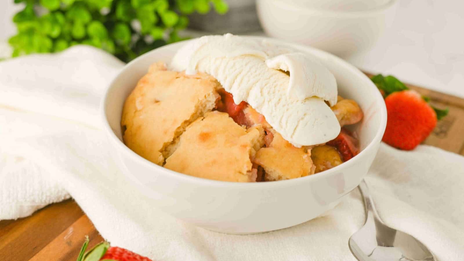 Strawberry cobbler baked with soft fruit filling and biscuit topping.